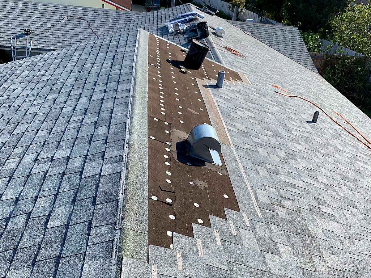 Completed shingle roof and ridge vents on an insurance-claim replacement