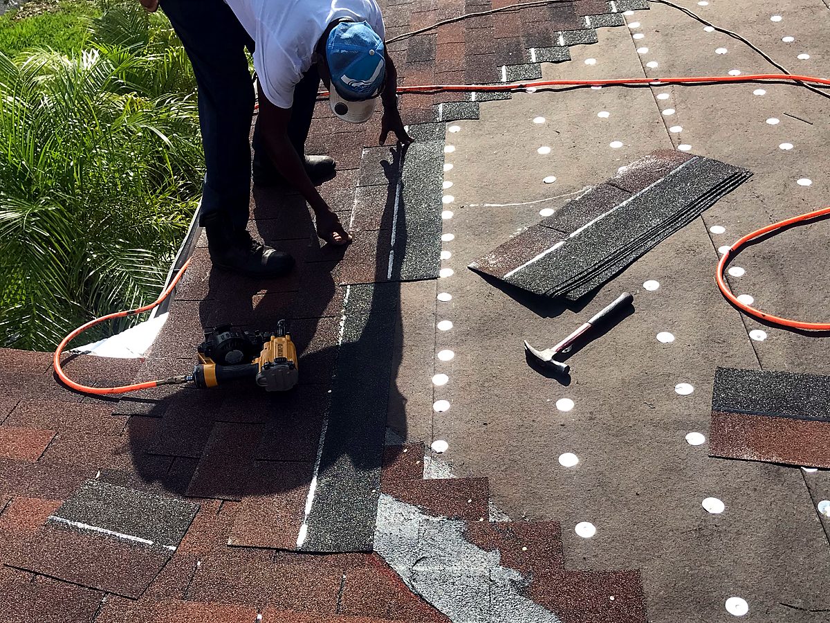 Installing new shingles over underlayment on an insurance-claim roof replacement