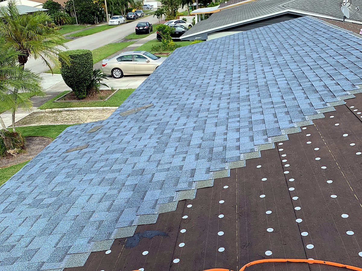 New shingle coverage progressing over underlayment on a claim roof replacement